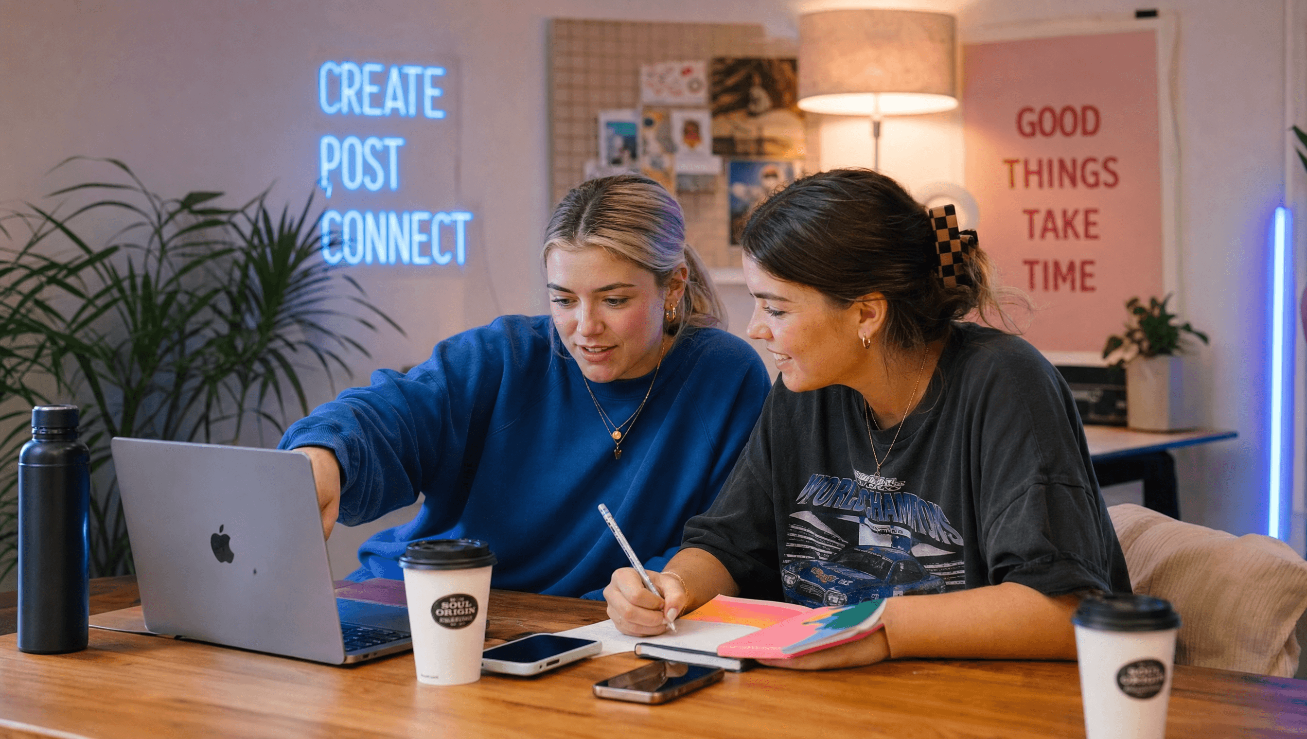 Social media agency team reviewing content strategy on laptop in a creative workspace
