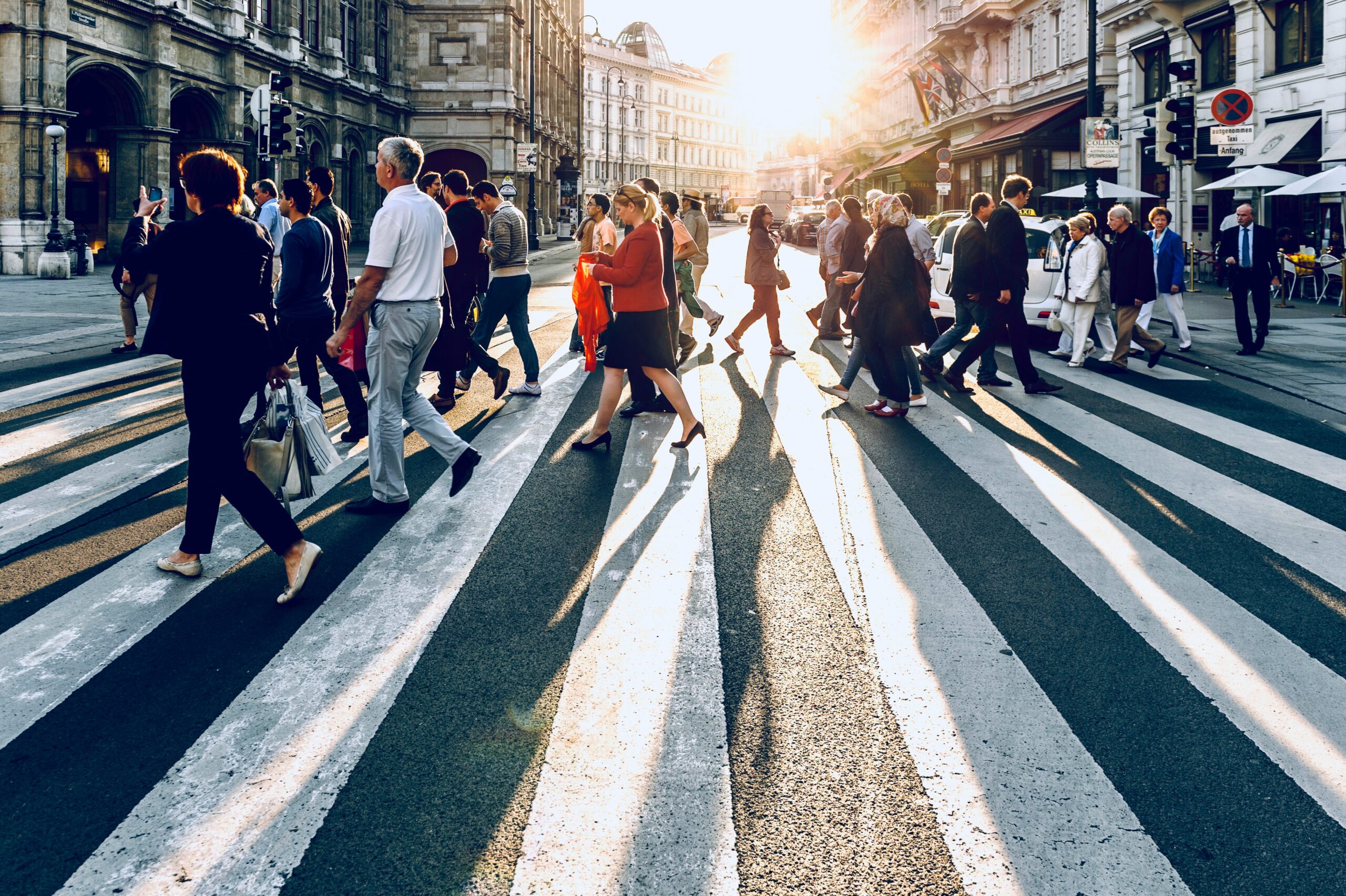 A diverse group of people on a crosswalk